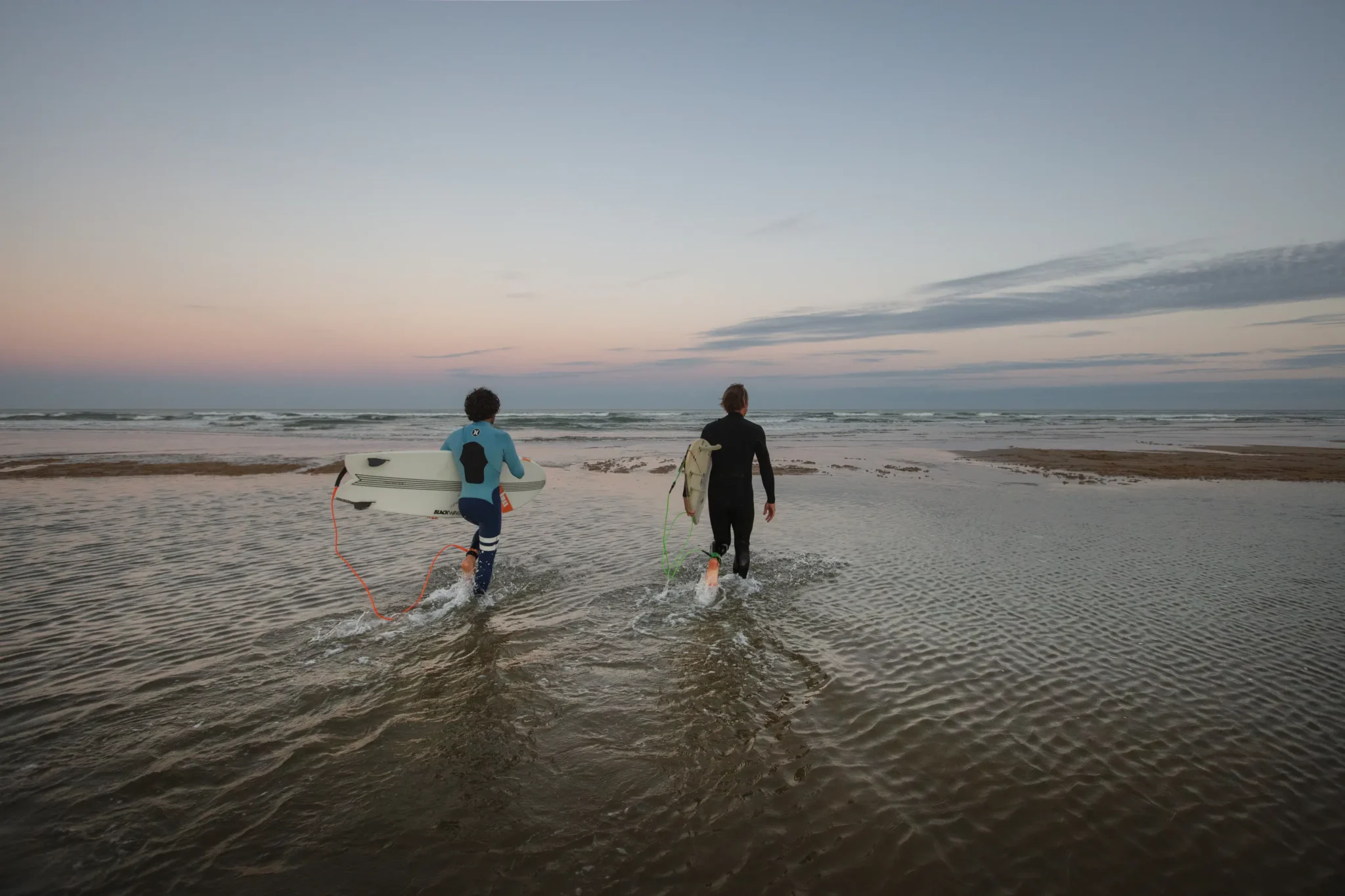 Surfeurs entrant dans l ocean 